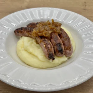 Salchichas con puré de patata y cebolla caramelizada